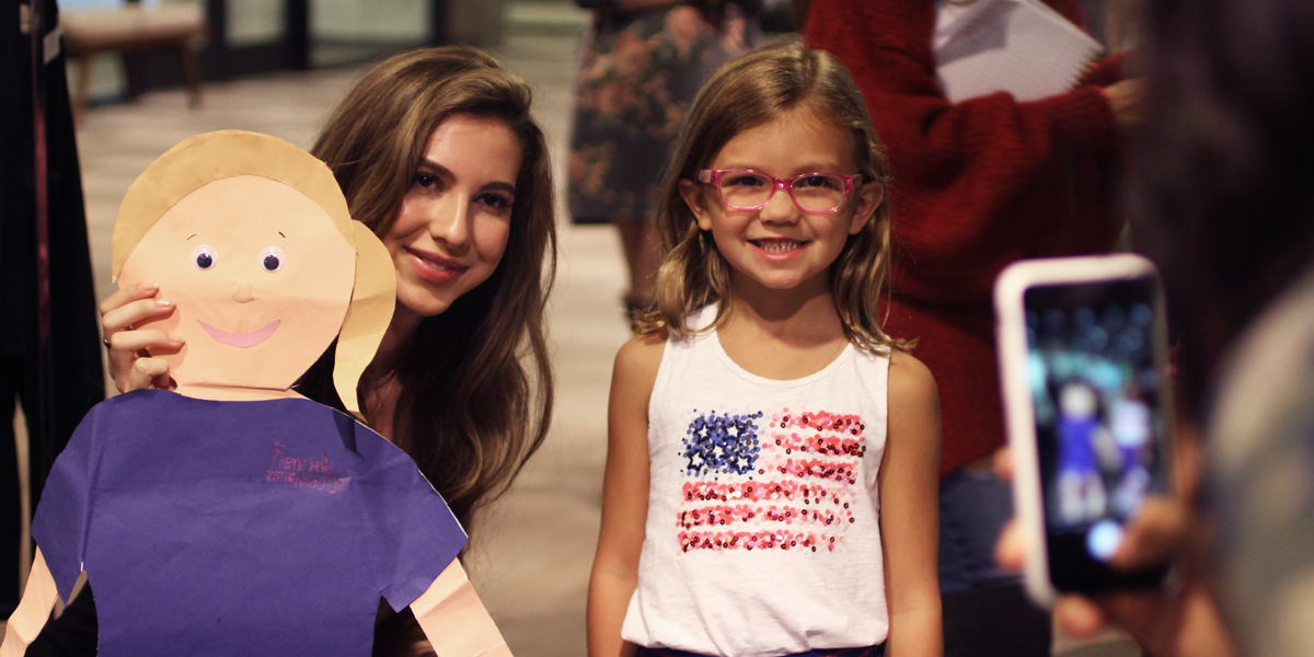 Isabella Rose Taylor stops for a photo op on International Day of the Girl at Fossil Group in Richardson TX