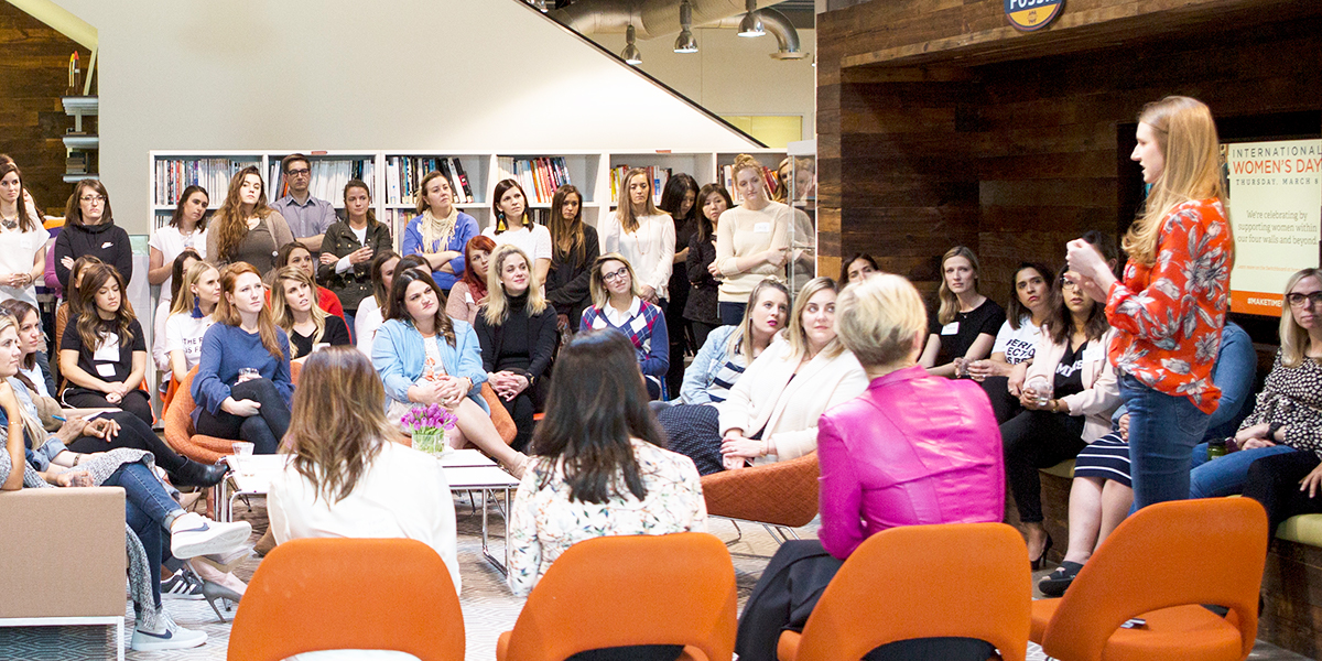 A Panelist of women in leadership take turns sharing a story at Fossil Group's Womens Day Happy Hour