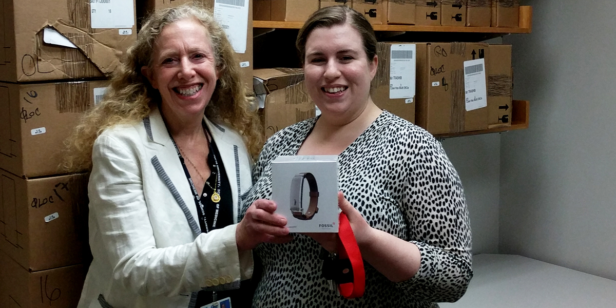 Community Partners of Fossil Group show off their fitness trackers donated by the accessory company