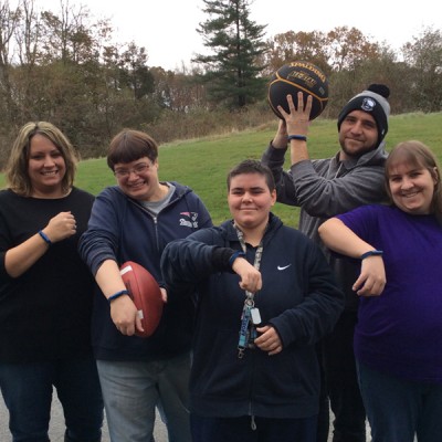 Community Partners of Fossil Group show off their fitness trackers donated by the accessory company