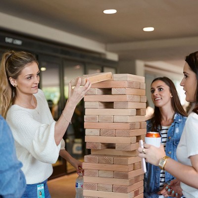 Fossil Group employees play giant Jenga at annual spring fest