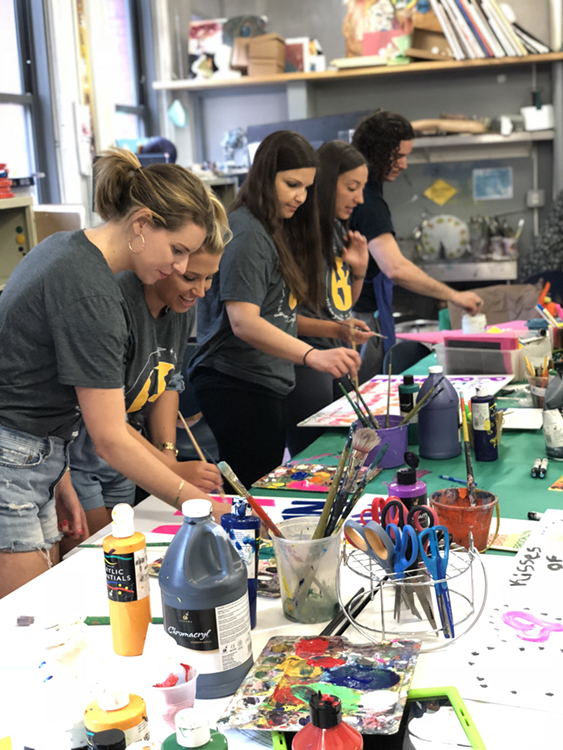 Fossil Group and Hetrick Martin employees make posters for NYC pride parade