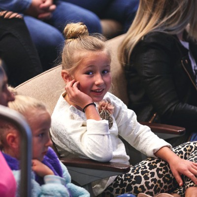 Fossil Group employees and their children watch keynote speeches at IDG event in Texas