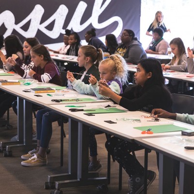 Fossil Group employees and their children attend a STEM workshop for IDG event