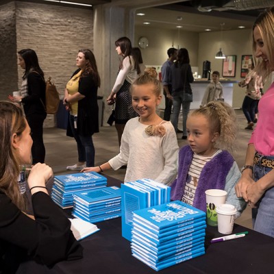 Aija Mayrock shares her best selling book with students at an IDG event at Fossil Group in Texas